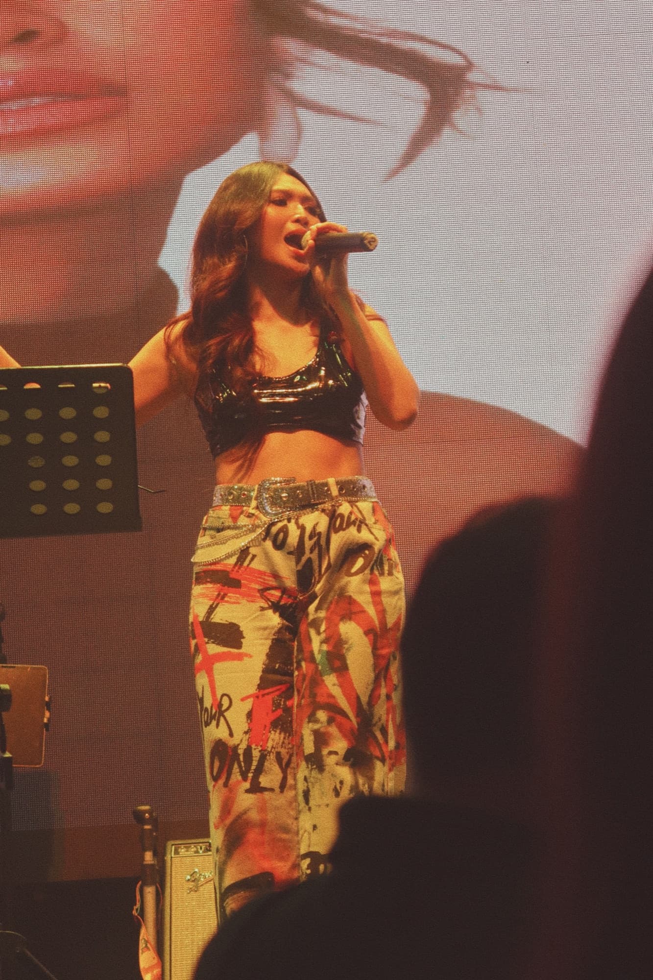 Close-up of Lyra singing into the microphone