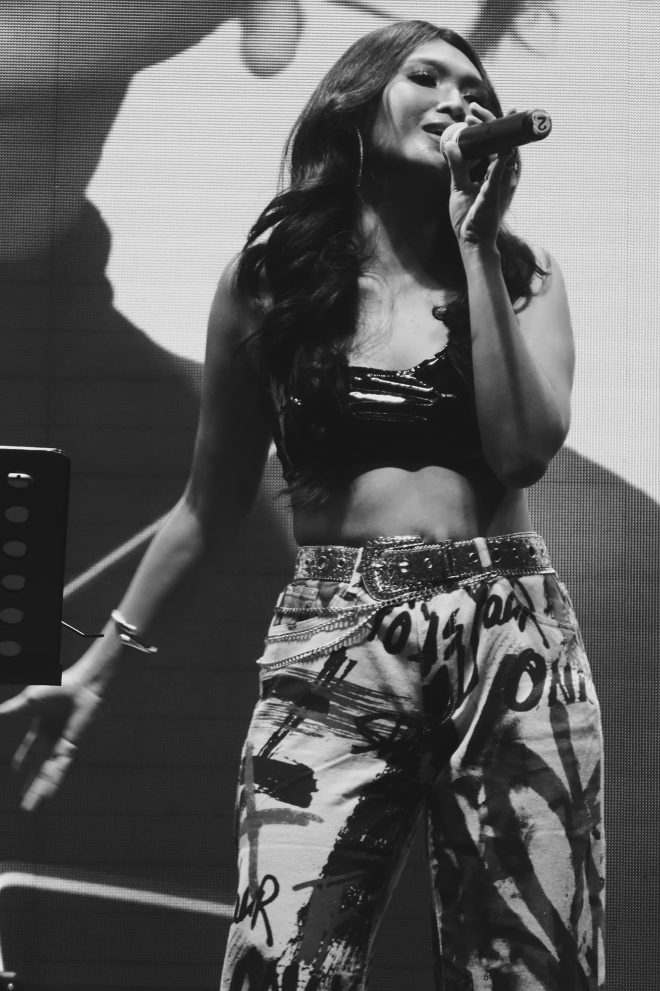 Black and white photo of Lyra singing on stage